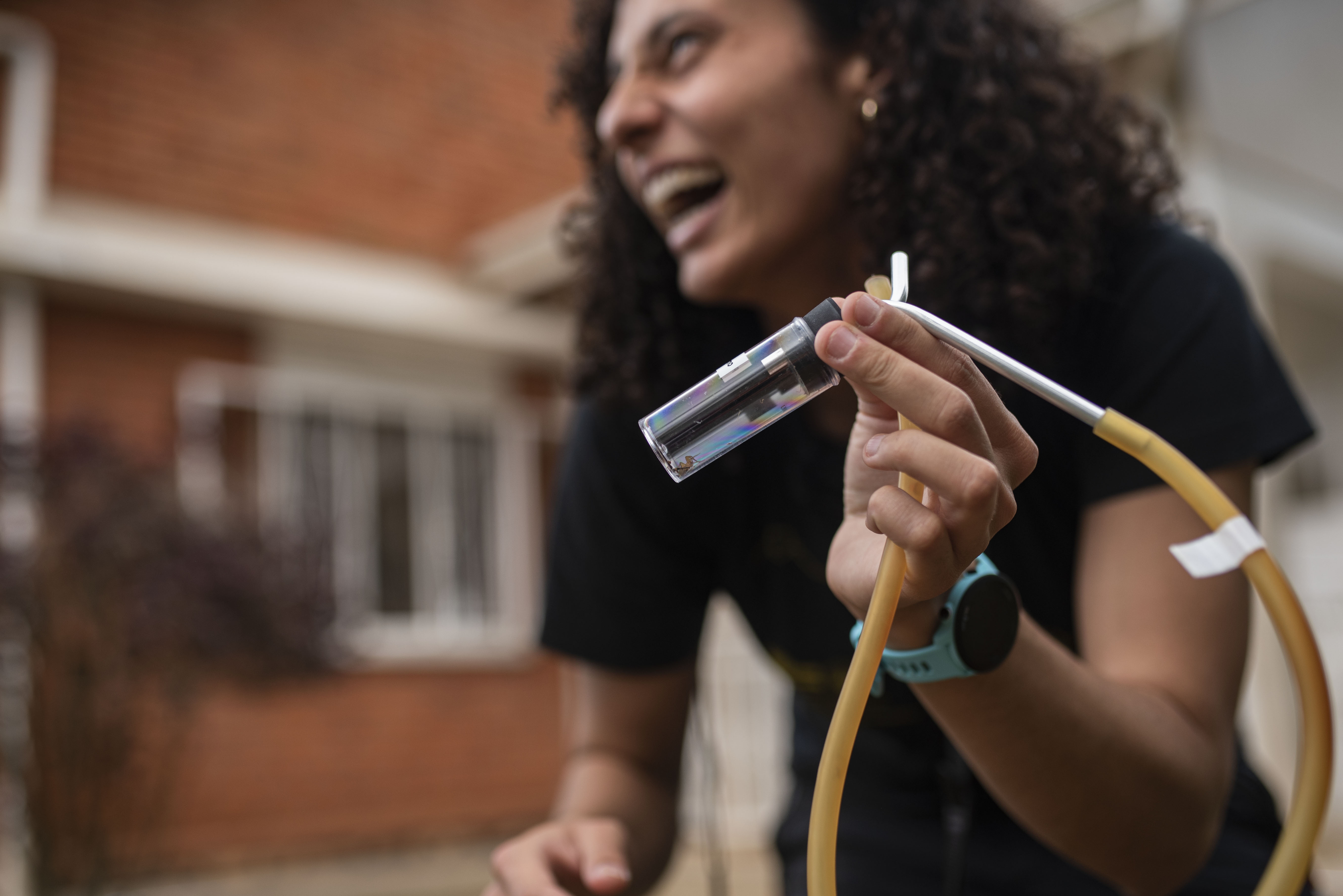 Scientist examining a specimen vial in the field